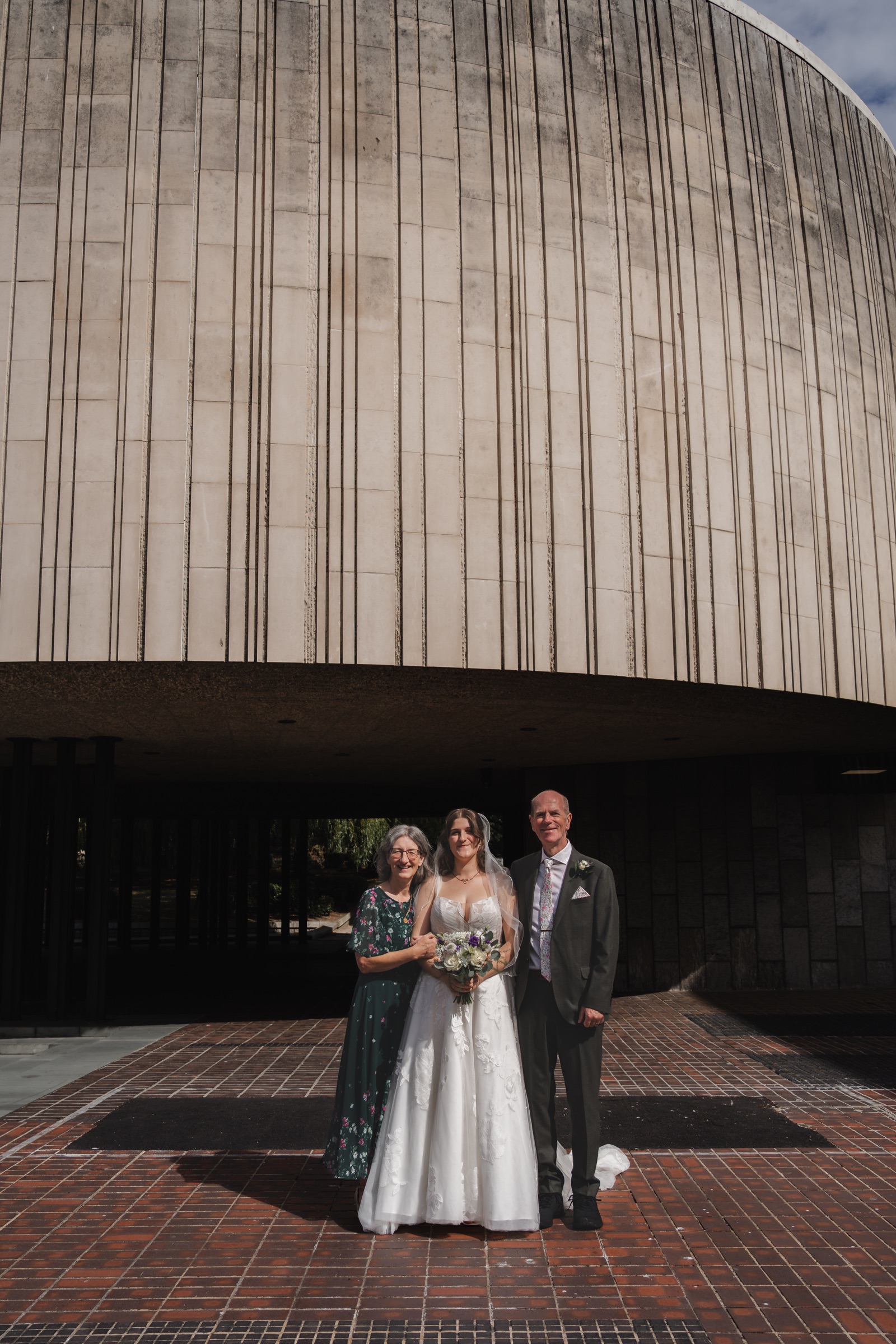 A bride with family outside a modern Newcastle city-centre building