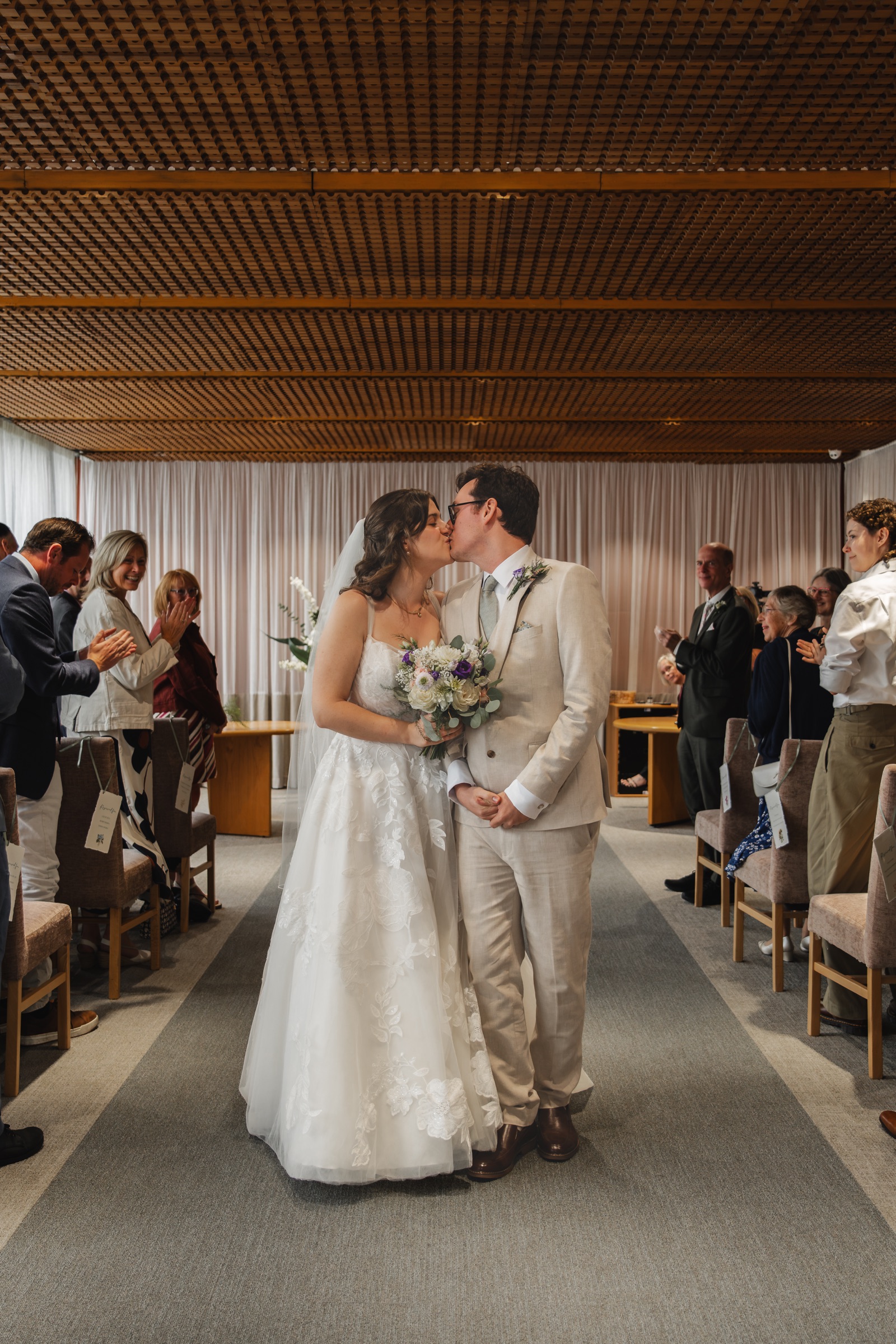 Ben and Tiffany sharing a kiss during their wedding ceremony